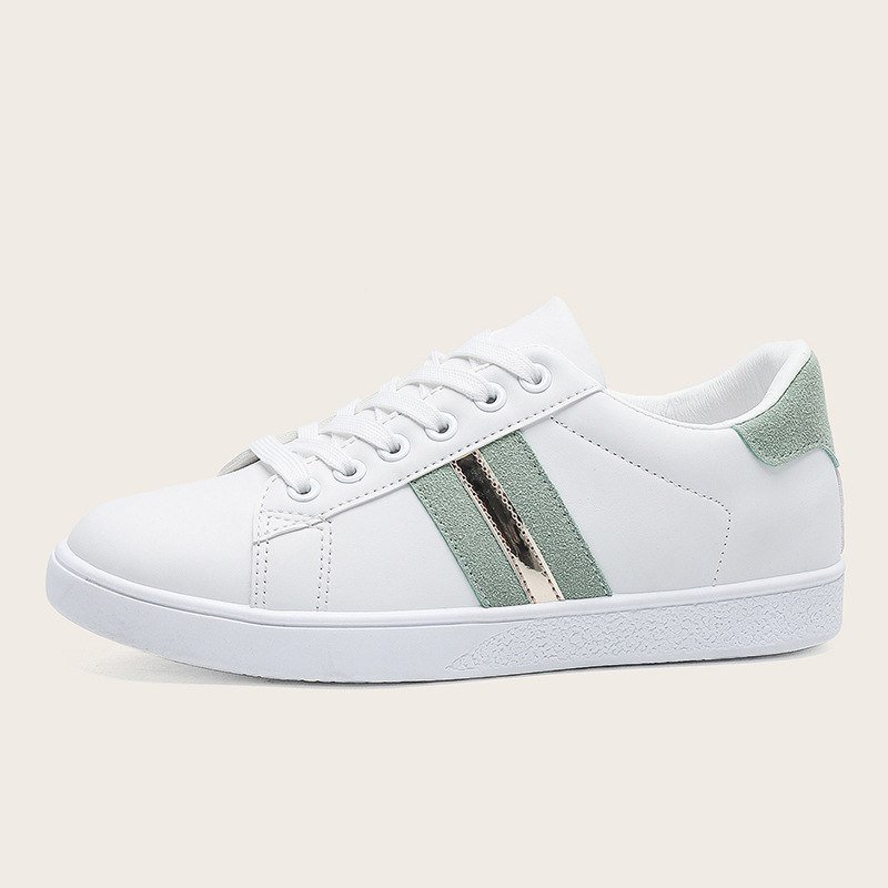 White sneakers with a green stripe detail for women 